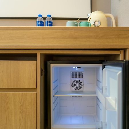 East Sacred Hotel: Tiananmen Square Proximity with Tourism Services Beijing Exterior photo A mini-refrigerator in a hotel room